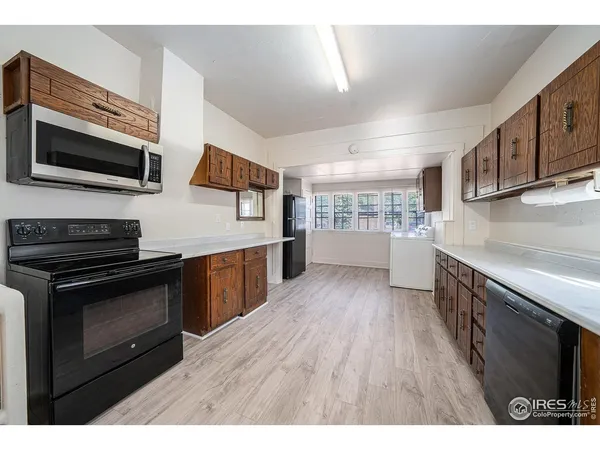 a kitchen with stainless steel appliances kitchen island granite countertop a stove a sink and a microwave