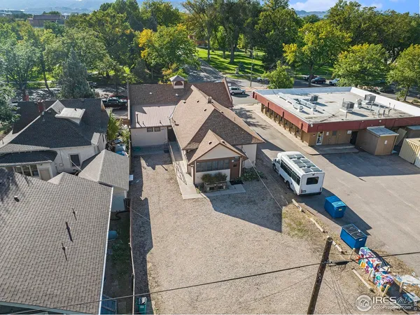 an aerial view of a house with swimming pool and outdoor seating