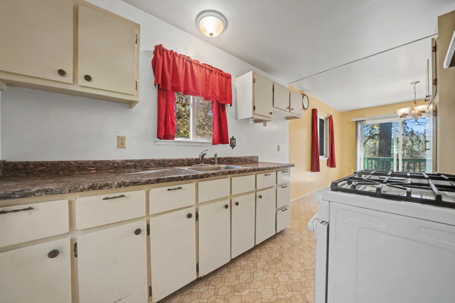 14371 Tobacco Road Pine Grove, CA 95665 - Photo 12 of 38 a kitchen with granite countertop a sink dishwasher a stove and a refrigerator