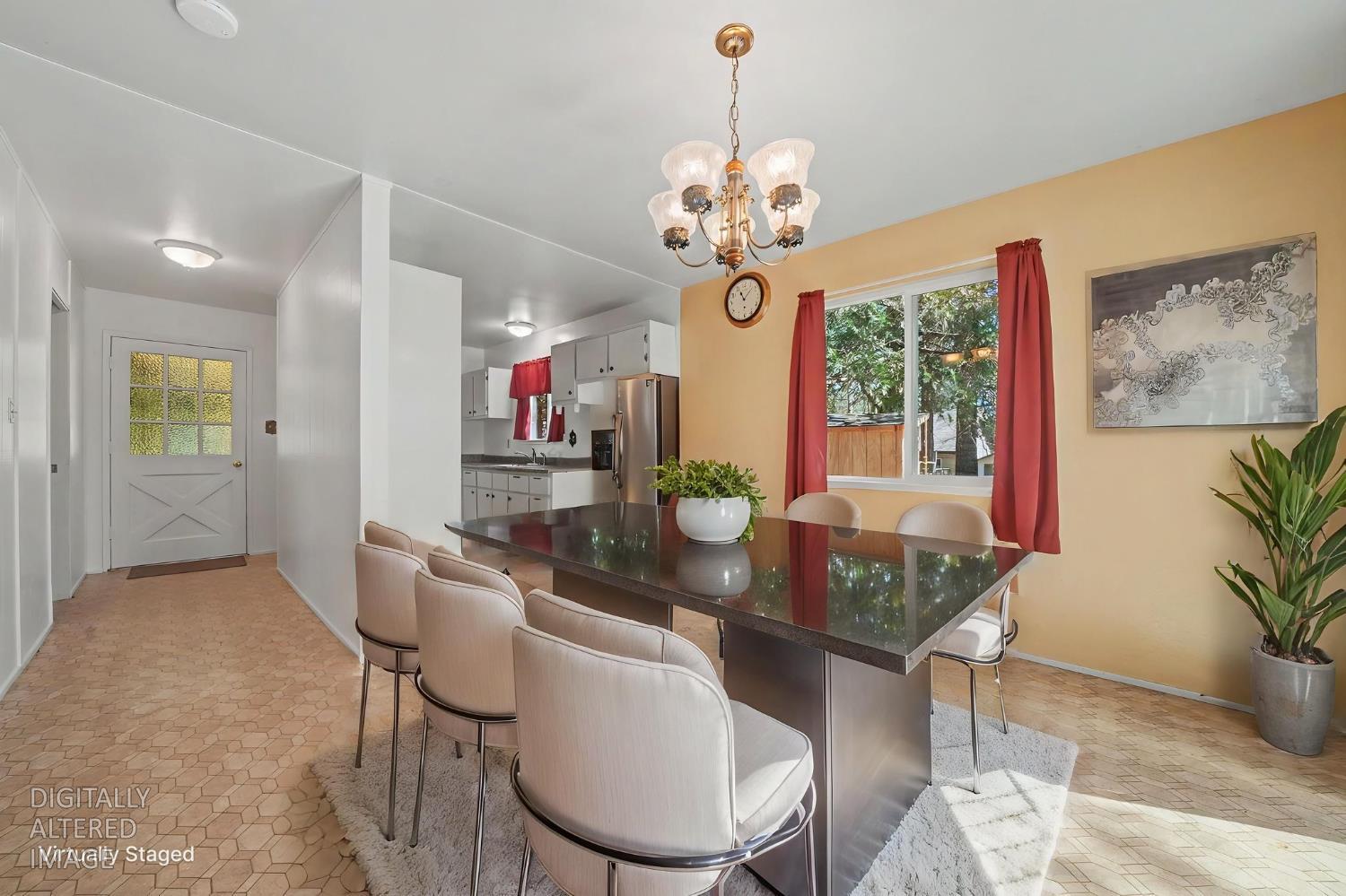 14371 Tobacco Road Pine Grove, CA 95665 - Photo 4 of 38 a view of a dining room with furniture a chandelier and wooden floor