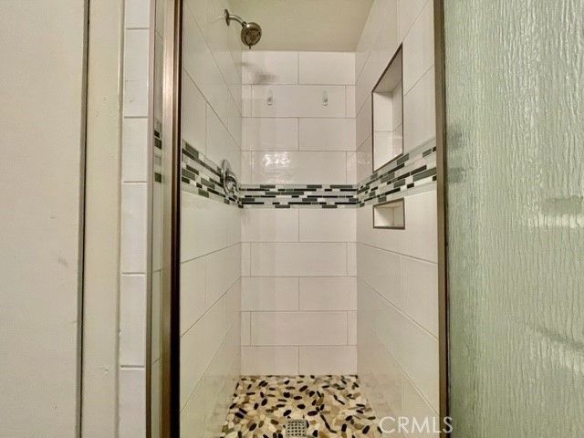 a bathroom with a glass shower door