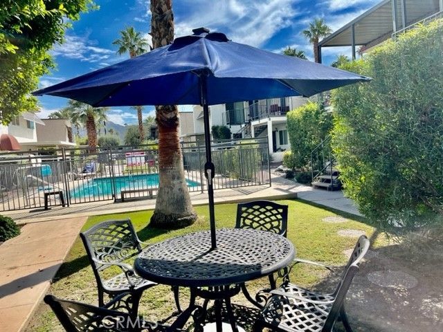 a patio with a patio table and chairs