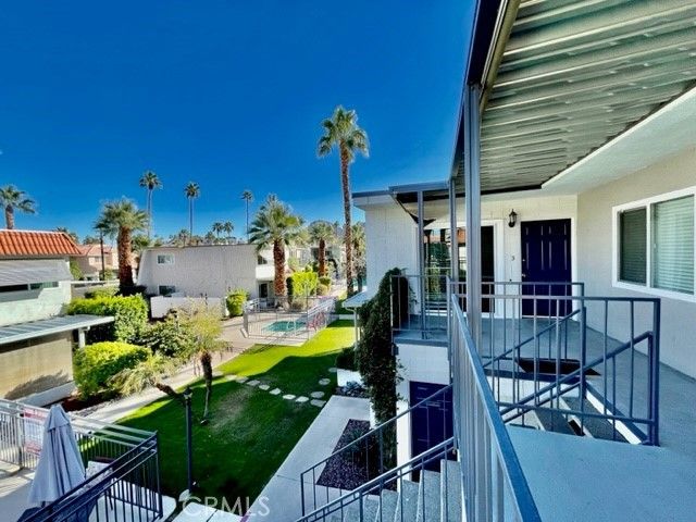 a view of a house with backyard water fountain and sitting area