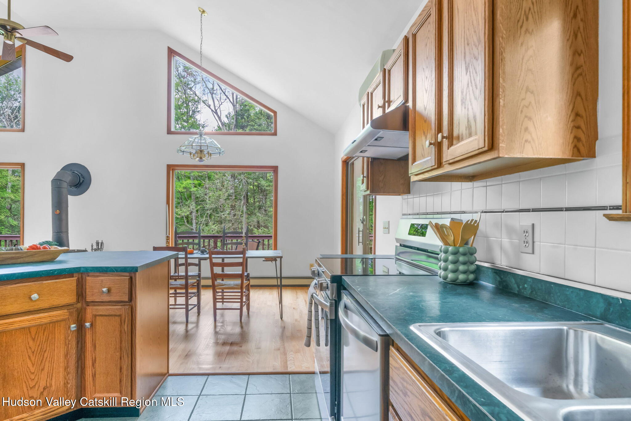 650 Beaverkill Road Olivebridge, NY 12461 - Photo 11 of 31 a kitchen with stainless steel appliances granite countertop a sink a stove and a wooden cabinets