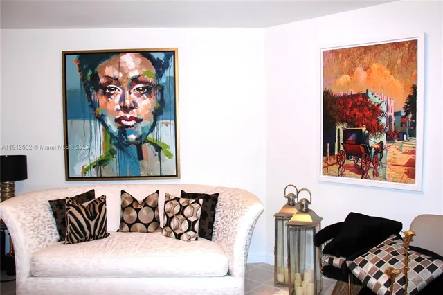 a living room with furniture and wall paintings