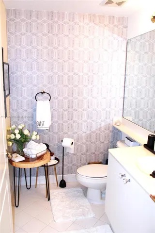 a bathroom with a toilet a sink and a mirror