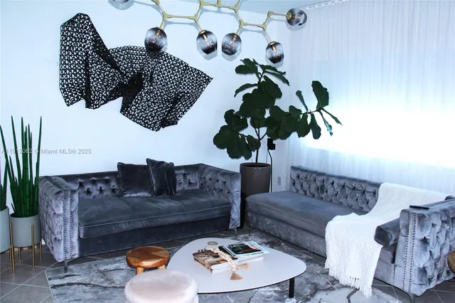 a living room with furniture flowerpot and wooden floor