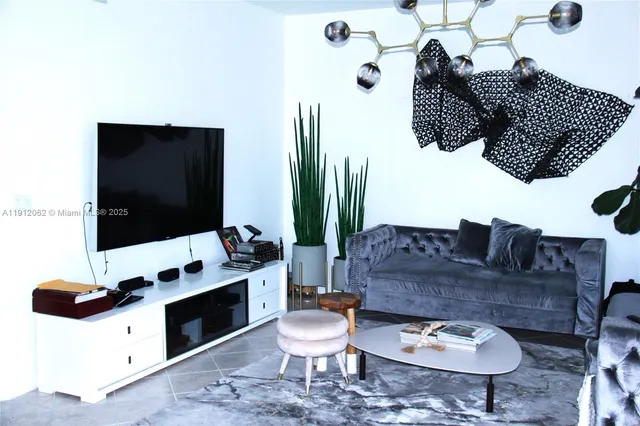 a living room with furniture and flat screen tv