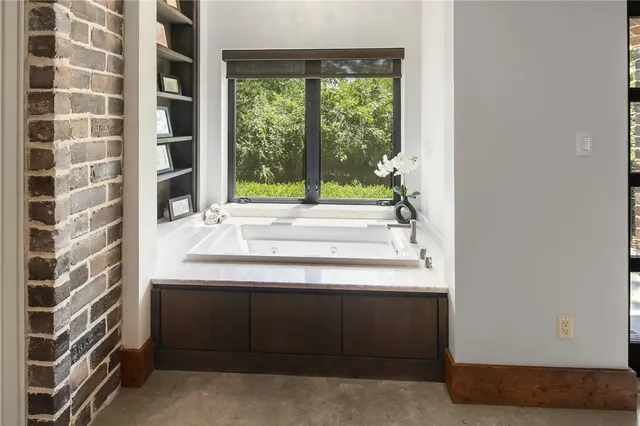 a dining hall with stainless steel appliances granite countertop a barbecue grill and a wooden floor