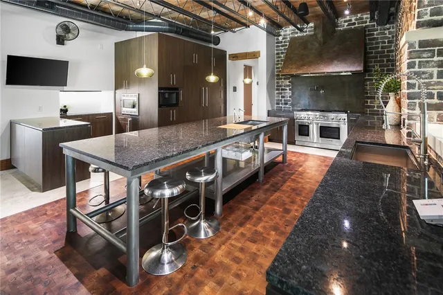a outdoor living room with furniture and a floor to ceiling window
