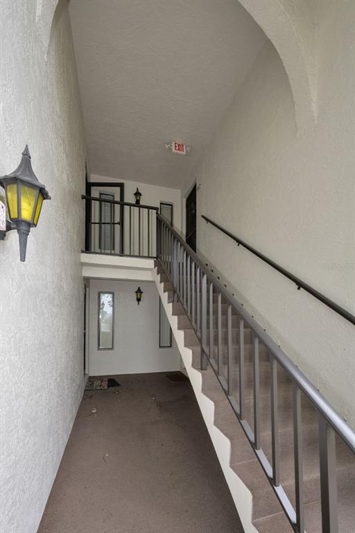 2687 Pine Ridge Way South, Unit B2 Palm Harbor, FL 34684 - Photo 3 of 68 a view of a hallway with windows