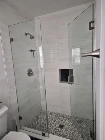 a bathroom with a toilet and a shower