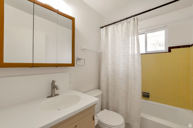 447 550 South Bountiful, UT 84010 - Photo 18 of 25 Bathroom featuring a vanity with an integrated sink, a brushed nickel faucet, and a wood-framed medicine cabinet