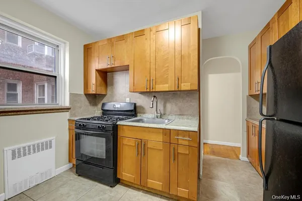 a kitchen with stainless steel appliances granite countertop a stove a refrigerator and a sink