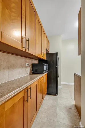 a kitchen with stainless steel appliances granite countertop a refrigerator a stove and a sink