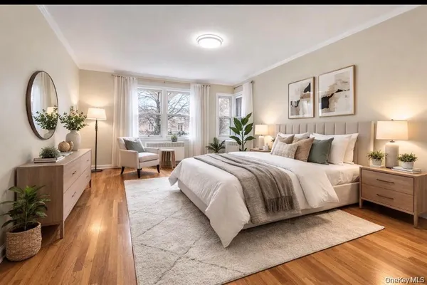 a spacious bedroom with a large bed and a chandelier