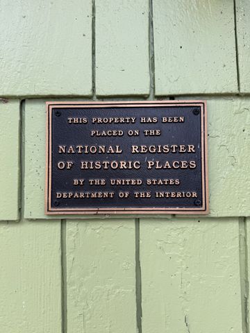 a living room with a fireplace cabinet and a fireplace