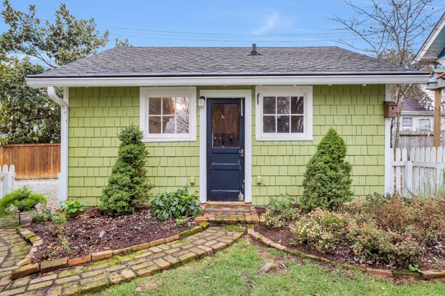 a bathroom with a granite countertop toilet sink and mirror