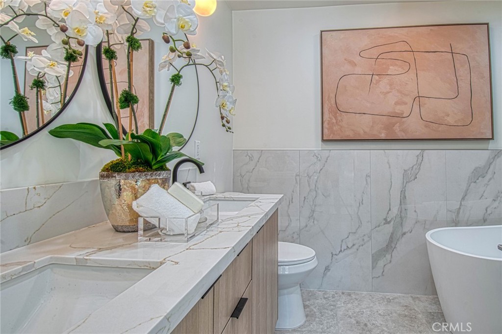 39 Seton Road Irvine, CA 92612 - Photo 15 of 28 a bathroom with a granite countertop sink a toilet and a bathtub