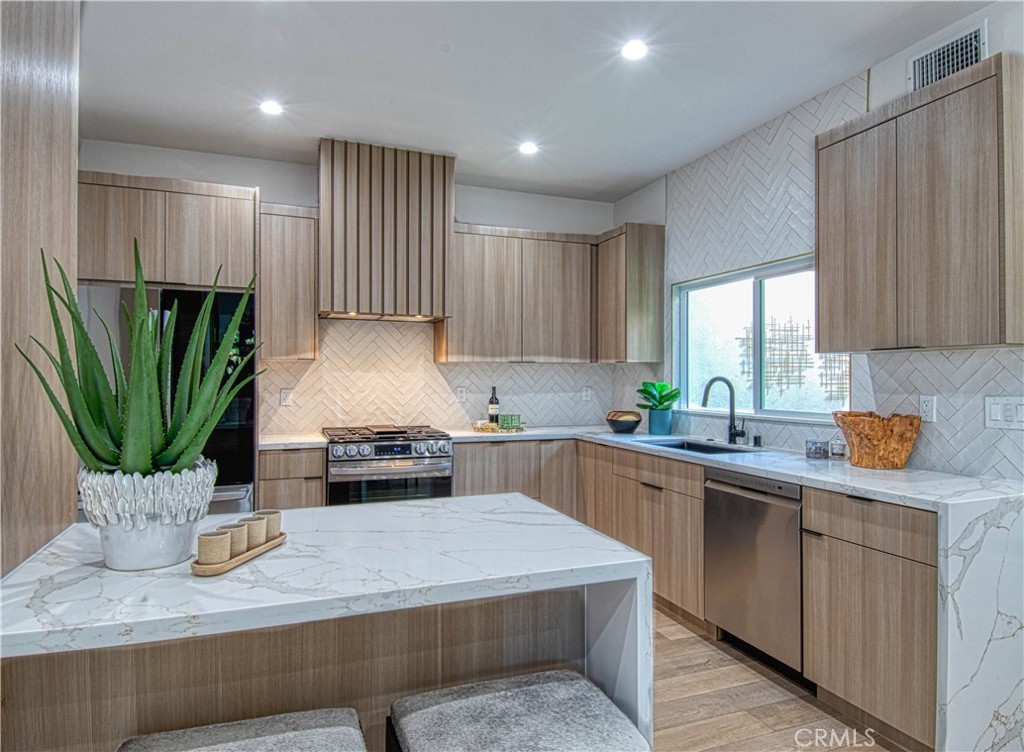 39 Seton Road Irvine, CA 92612 - Photo 6 of 28 a kitchen with a refrigerator and a sink