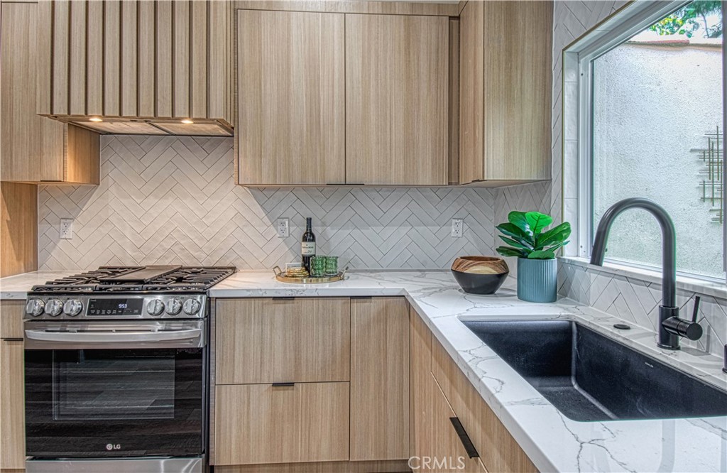 39 Seton Road Irvine, CA 92612 - Photo 8 of 28 a kitchen with granite countertop a sink stove and cabinets