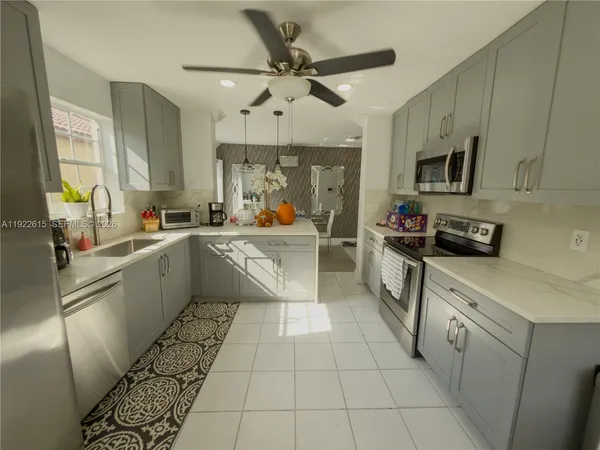 a kitchen with a sink appliances and cabinets