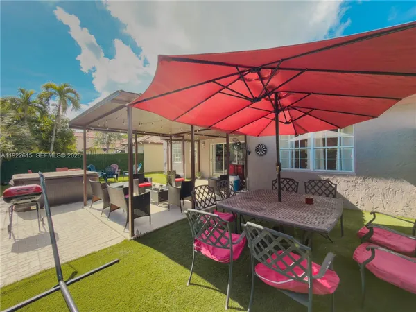 a patio with tables and chairs