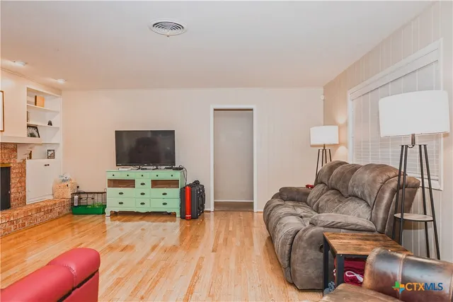 a view of a dining room with furniture and a kitchen