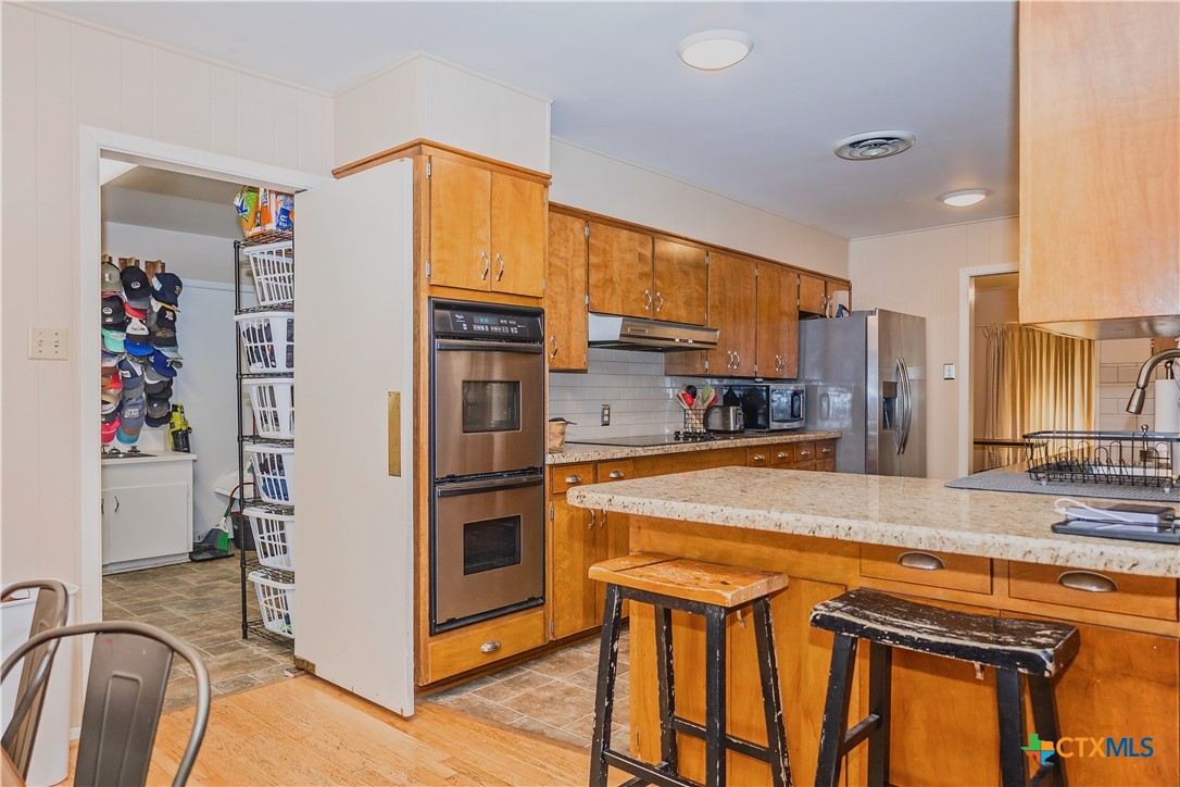 111 Dover Dell Street Victoria, TX 77904 - Photo 17 of 36 a kitchen with stainless steel appliances granite countertop a refrigerator and a sink