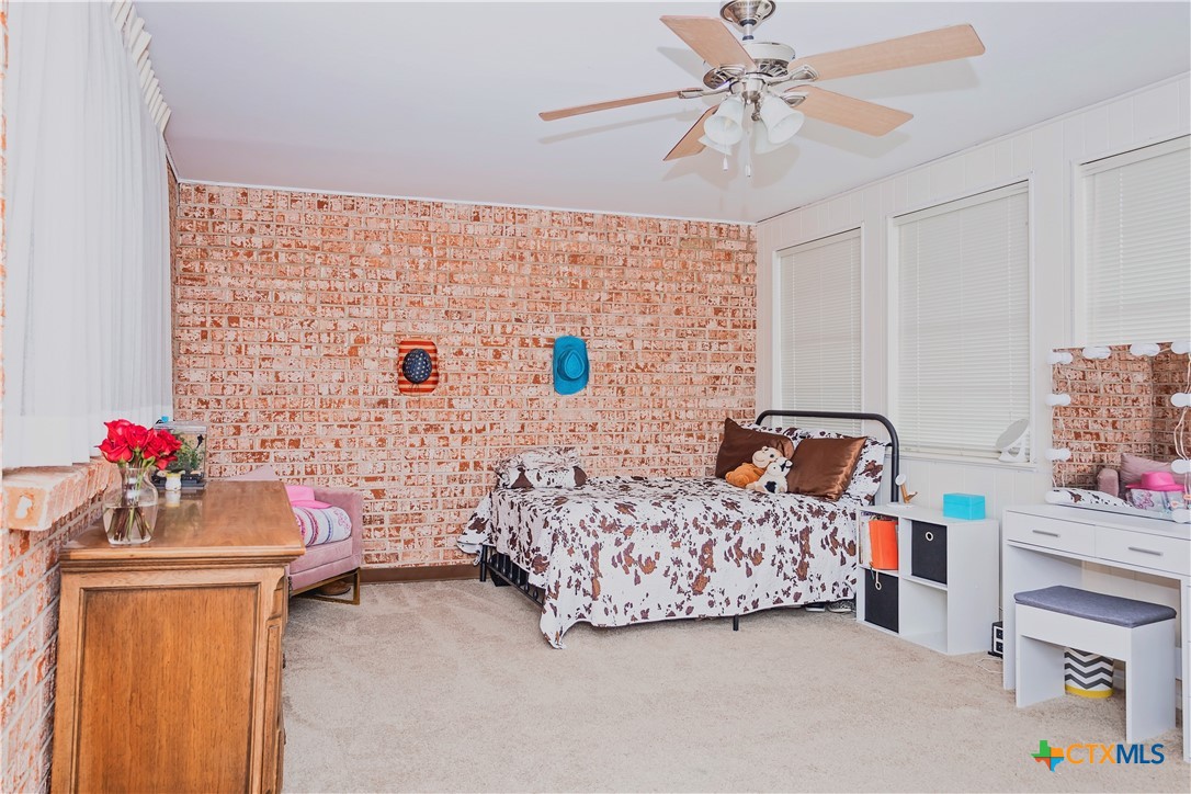 111 Dover Dell Street Victoria, TX 77904 - Photo 23 of 36 a bedroom with a bed and a chandelier