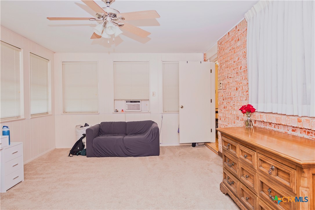 111 Dover Dell Street Victoria, TX 77904 - Photo 24 of 36 a bedroom with a bed and a chandelier