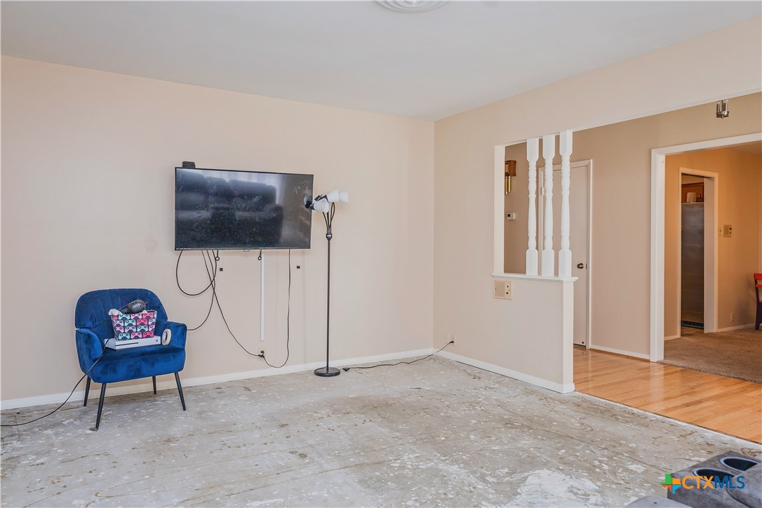 111 Dover Dell Street Victoria, TX 77904 - Photo 5 of 36 a living room with furniture a flat screen tv and a window