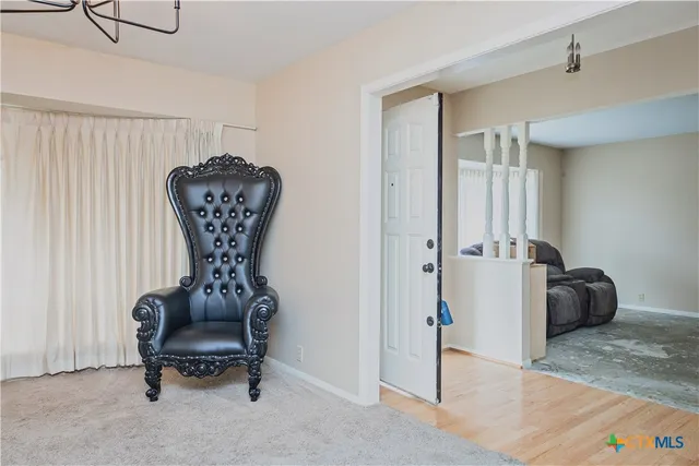 a living room with furniture and a lamp