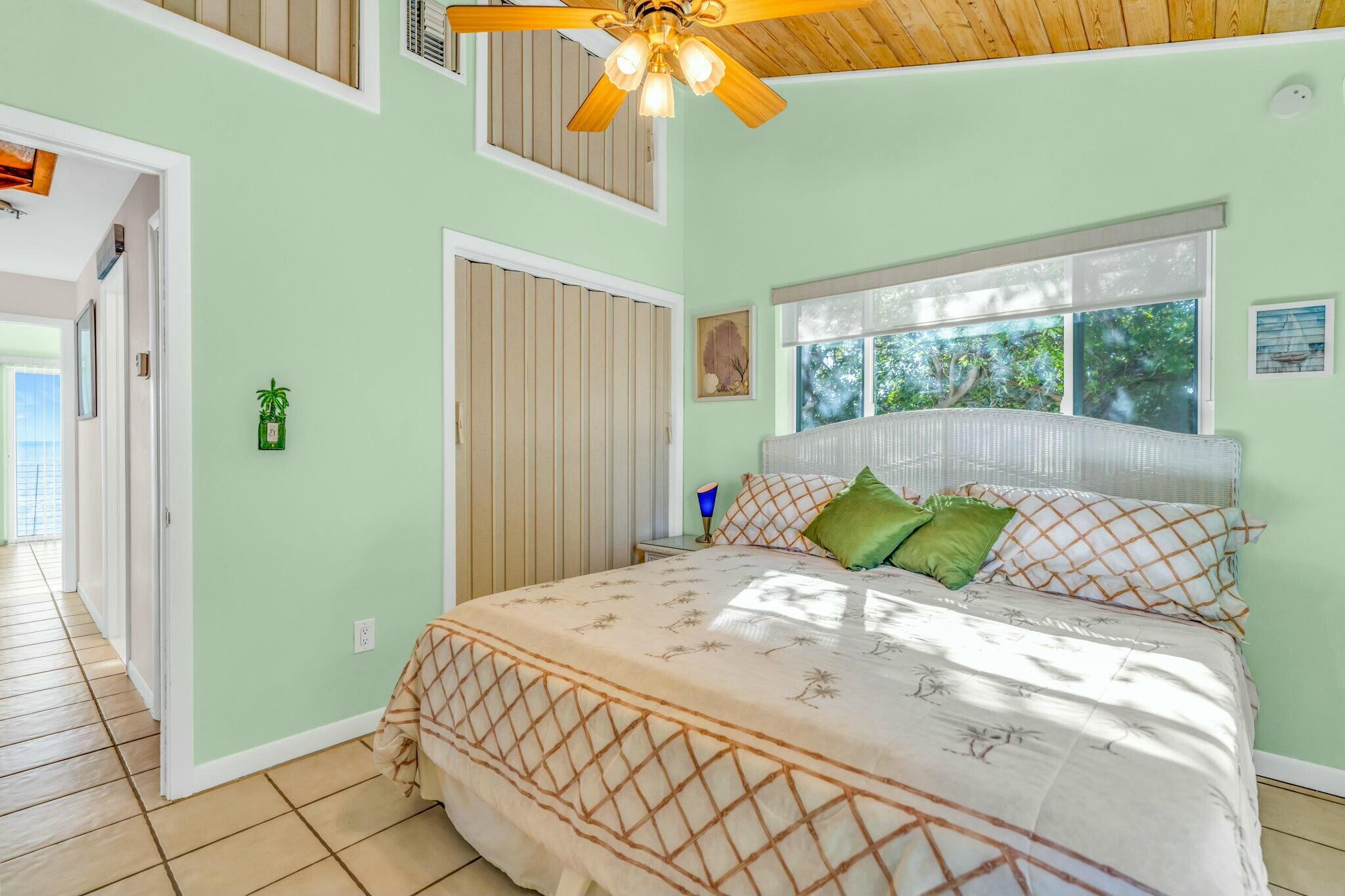 1073 Long Beach Drive Big Pine Key, FL 33043 - Photo 33 of 55 a bedroom with a bed and a chandelier
