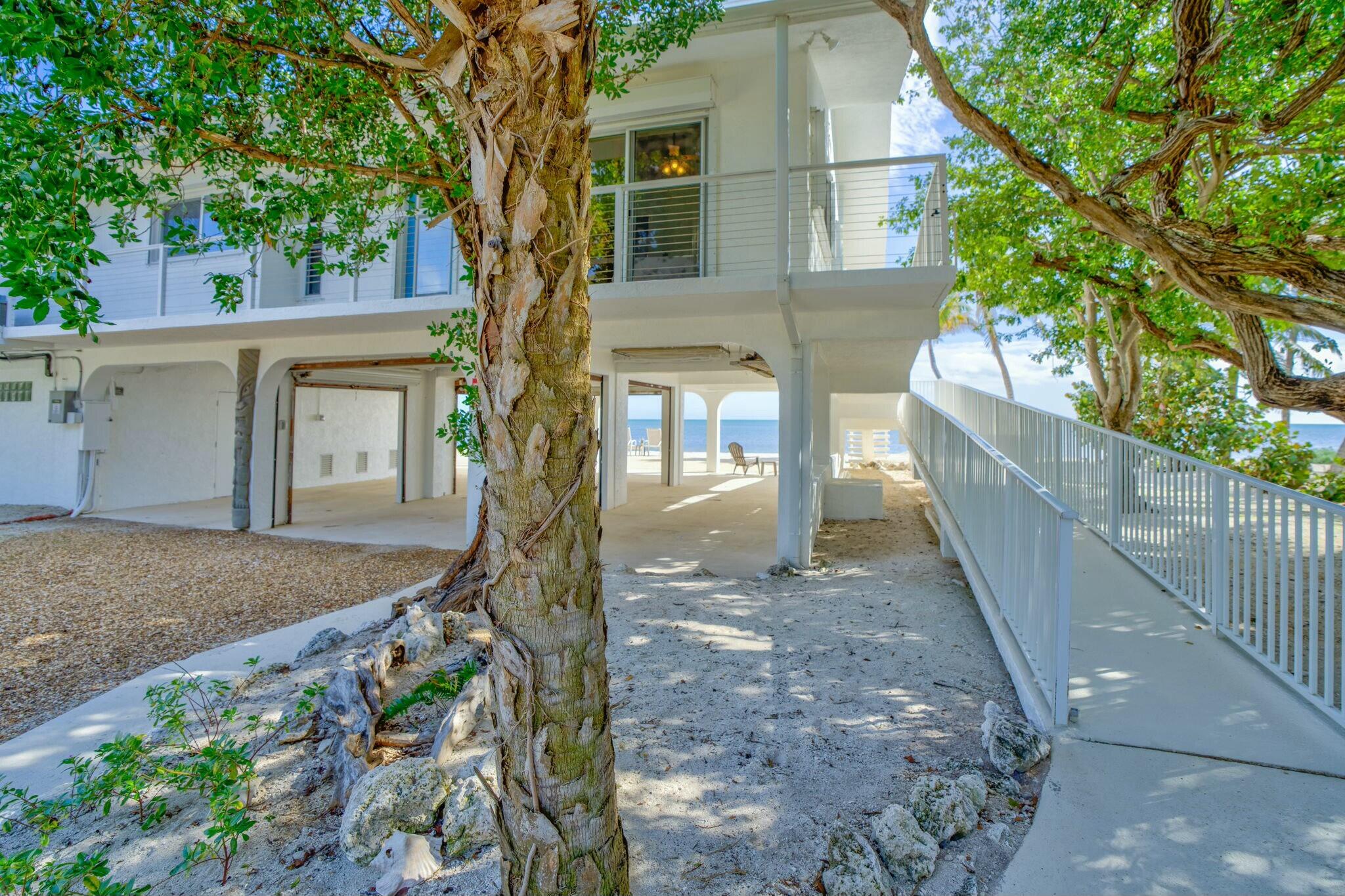 1073 Long Beach Drive Big Pine Key, FL 33043 - Photo 8 of 55 a front view of a house with a tree