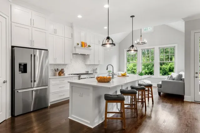 a kitchen with a refrigerator and a stove