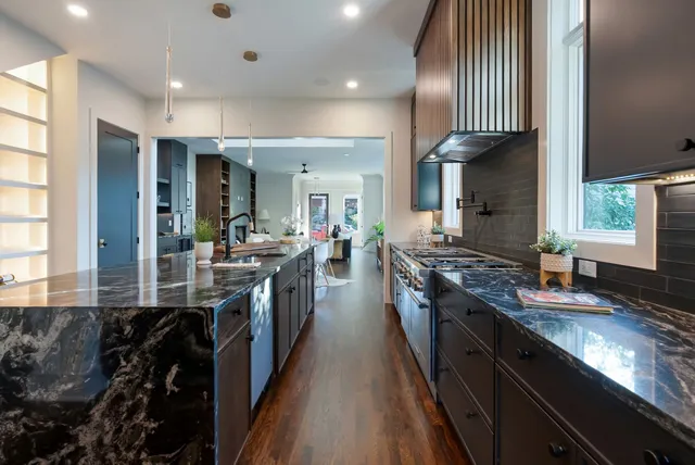 a bathroom with a sink vanity mirror and toilet