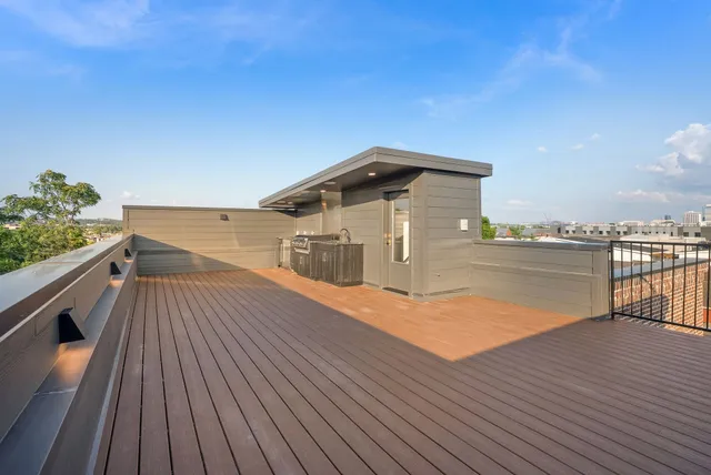 a dining room with wooden floor a glass table and chairs