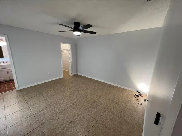 a view of a livingroom with a ceiling fan and window