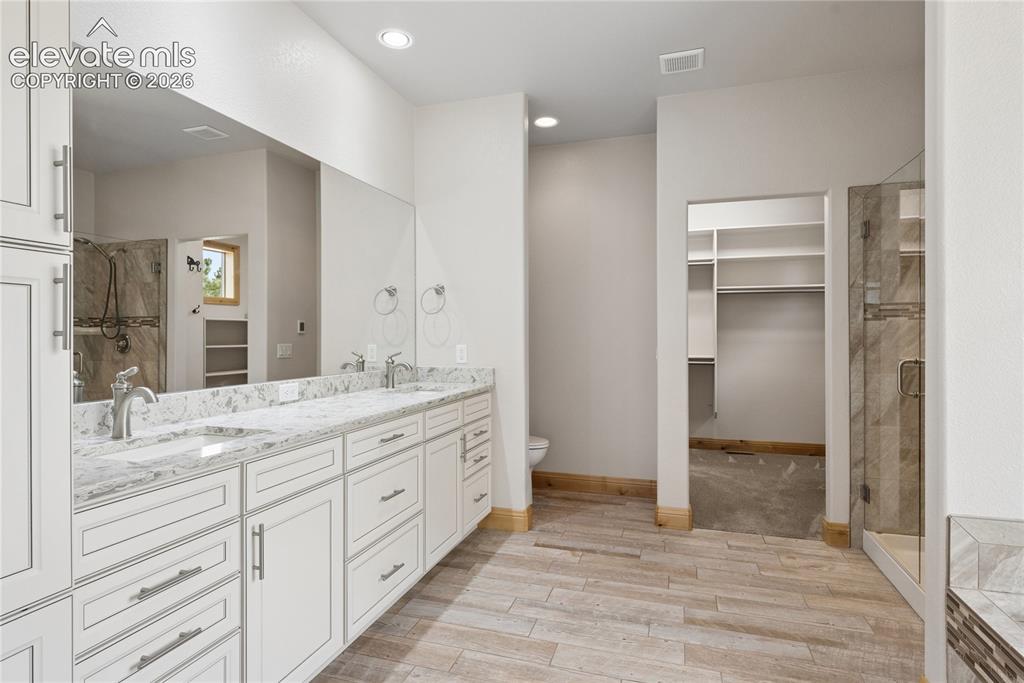 10840 Vollmer Road Colorado Springs, CO 80908 - Photo 26 of 49 a bathroom with a granite countertop sink mirror and