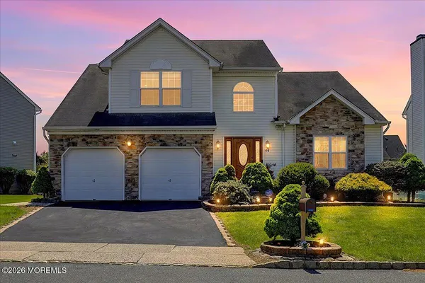 a front view of house with yard and car parked