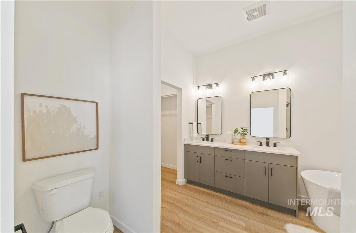 2032 South Mackinnon Lane Boise, ID 83706 - Photo 29 of 48 Full bath with a freestanding bath, double vanity, and light wood-style flooring