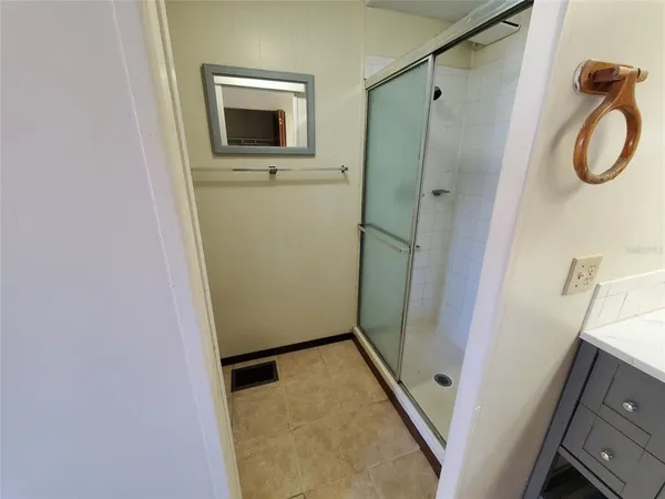 a bathroom with a shower and a sink