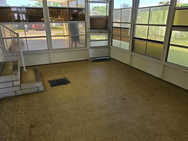 an empty room with sliding glass door