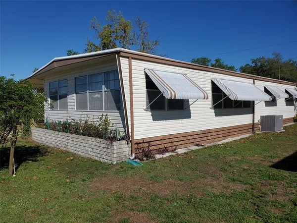 a view of front of house with a yard