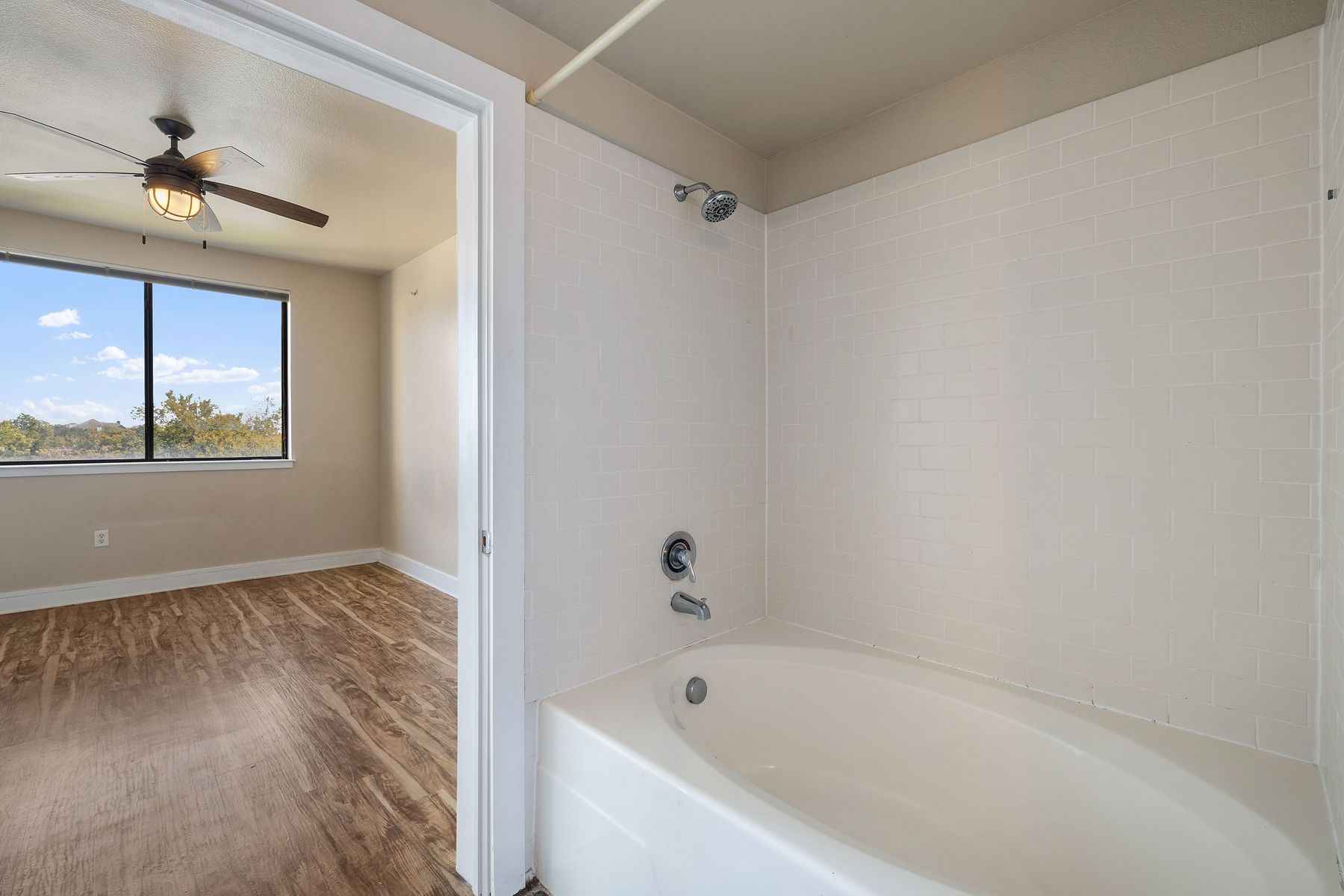 3016 Guadalupe Street, Unit 303 Austin, TX 78705 - Photo 13 of 15 a white bath tub sitting next to a window