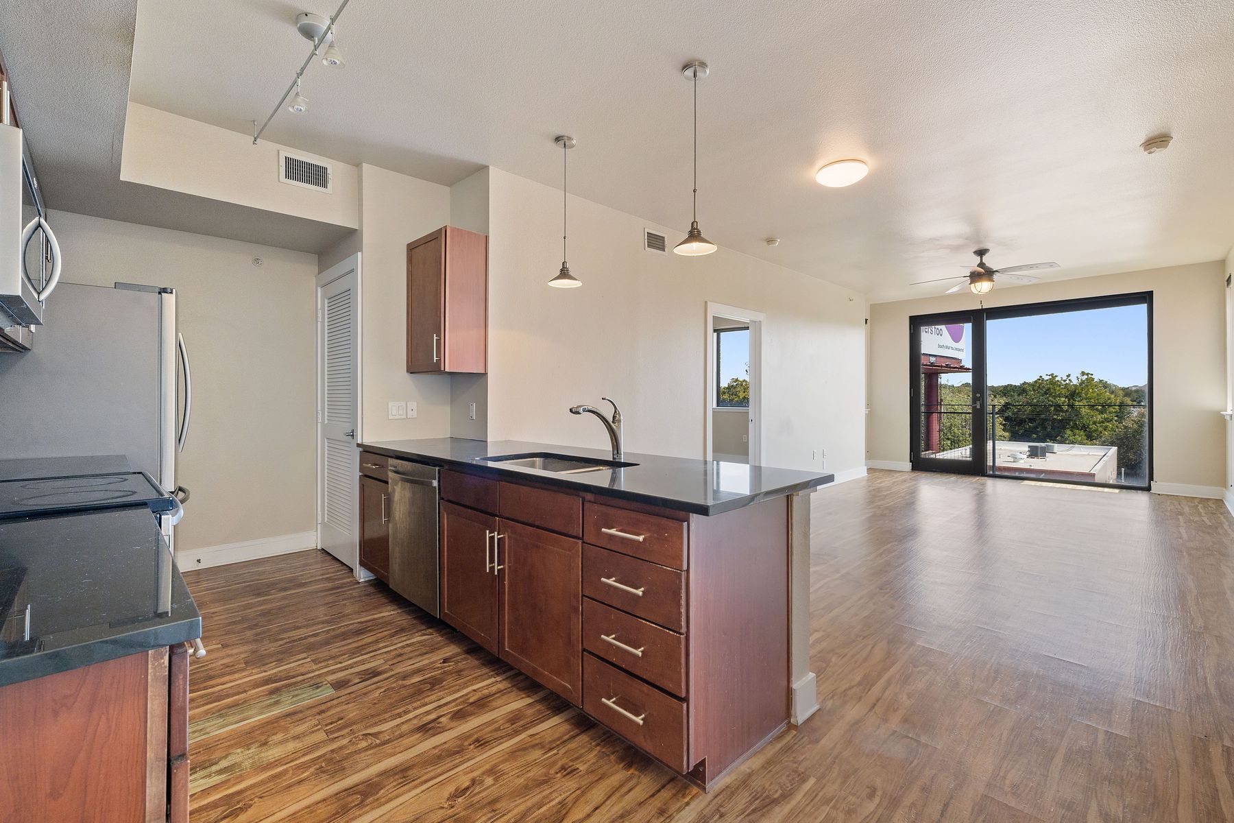 3016 Guadalupe Street, Unit 303 Austin, TX 78705 - Photo 2 of 15 a large kitchen with stainless steel appliances a large counter top a stove a sink and a refrigerator