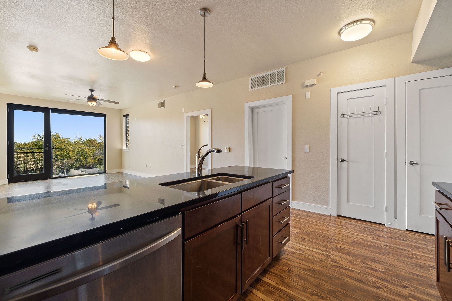 3016 Guadalupe Street, Unit 303 Austin, TX 78705 - Photo 4 of 15 a kitchen with a sink and a wooden floor