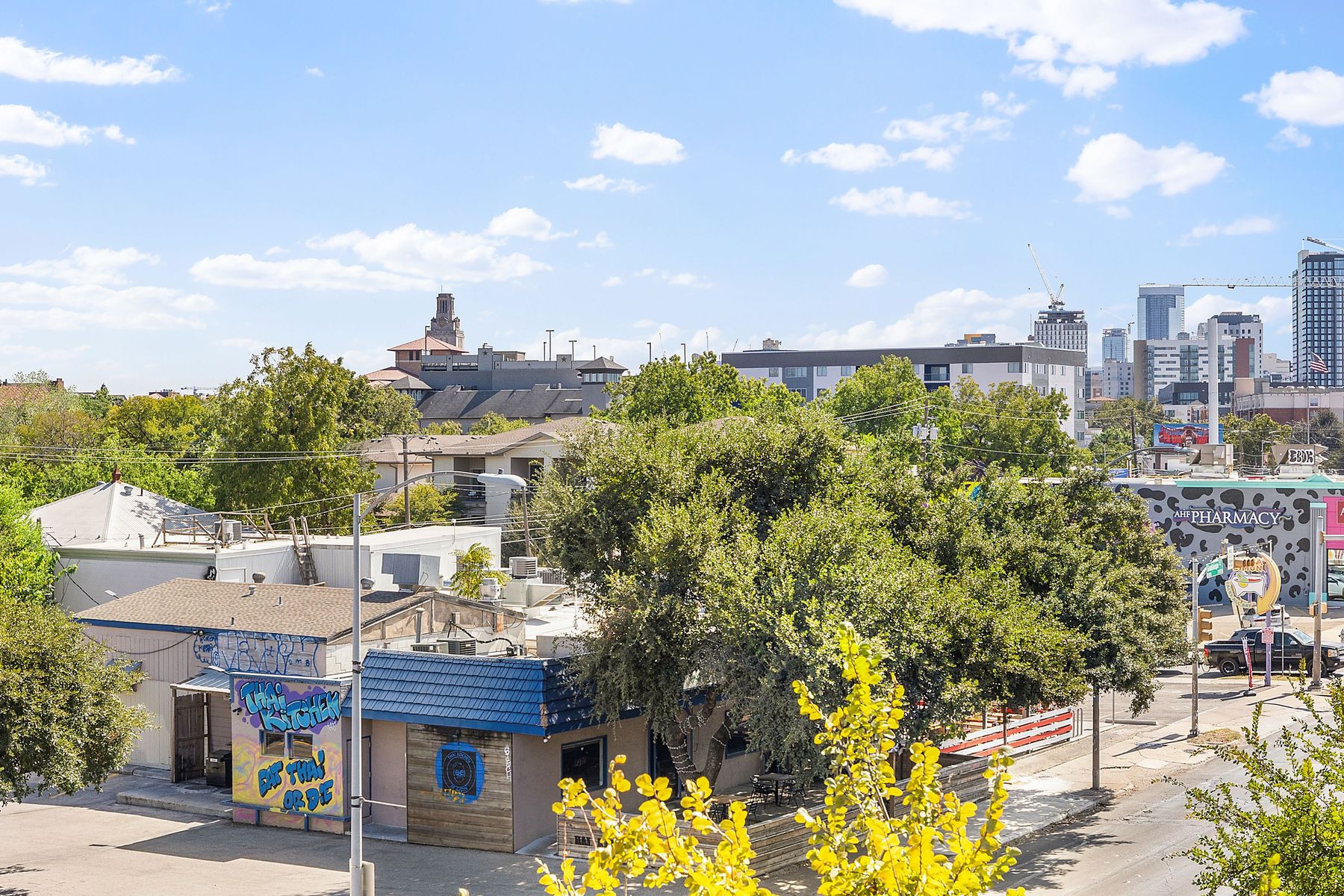 3016 Guadalupe Street, Unit 303 Austin, TX 78705 - Photo 7 of 15 a roof deck with table and chairs and potted plants