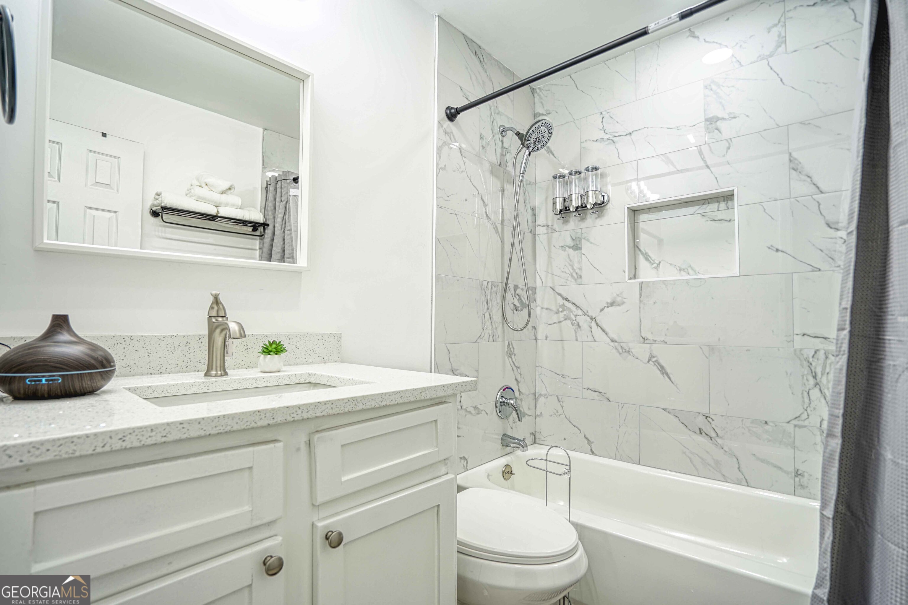 1827 Dunlap Avenue East Point, GA 30344 - Photo 21 of 32 a bathroom with a granite countertop sink mirror toilet and bathtub